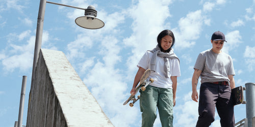 Two people wearing MiiR Apparel holding skateboards apparel-banner-1-desktop.jpg__PID:946b7814-c319-4ad2-a12a-fb5206ccfd0f