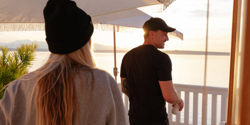 A couple wearing MiiR Apparel on a patio apparel-banner-2-desktop.jpg__PID:25d18c84-b1fc-483e-b44c-925192017059
