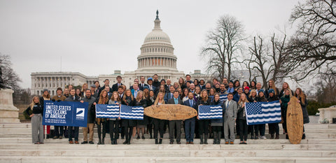 Surfriders foundation Washington DC holding signed surf board, activism