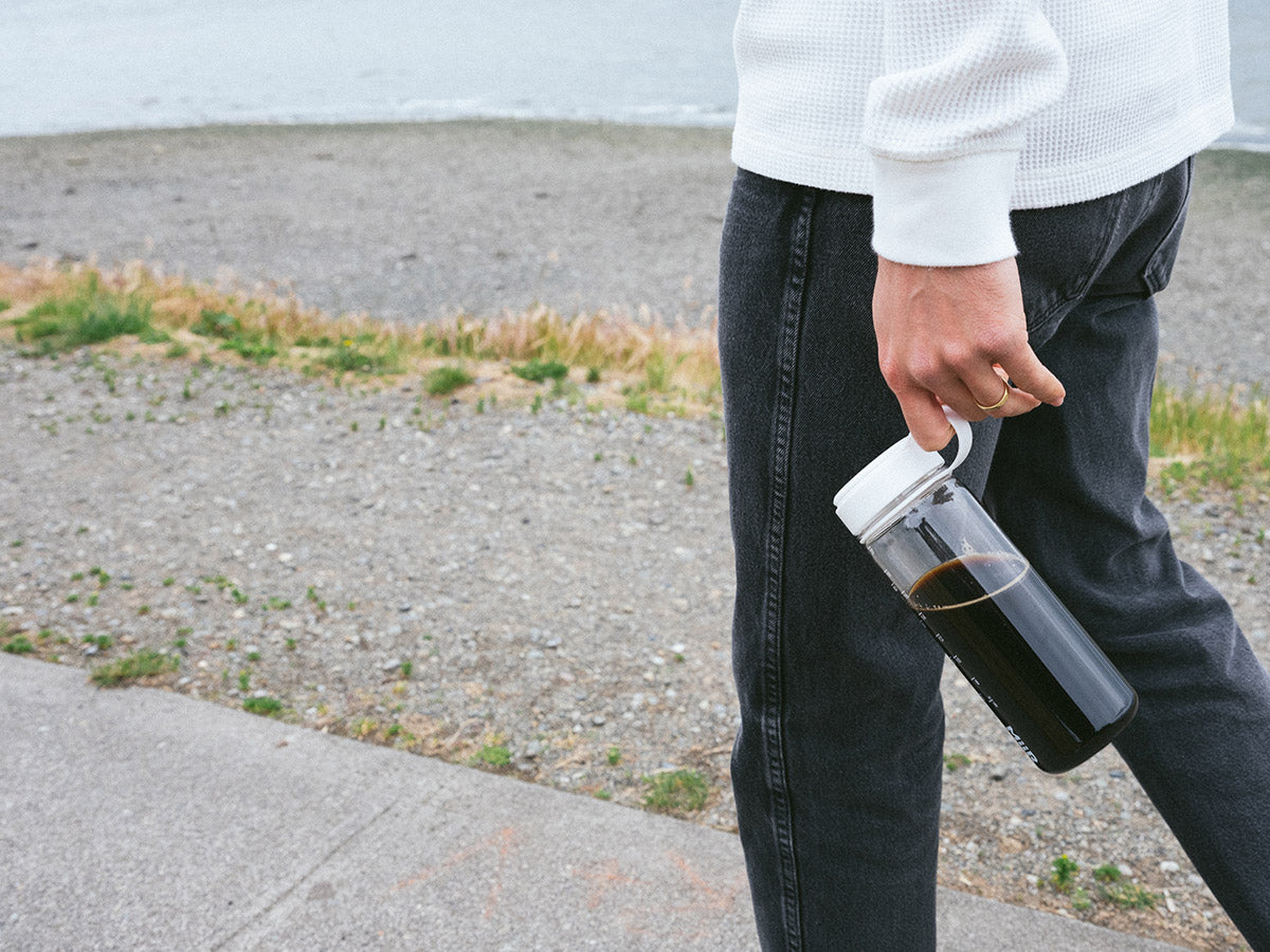 A person walking with the MiiR Everywhere Bottle