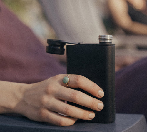 A hand holding the MiiR Aero Flask