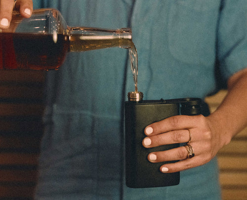Pouring a spirit into the MiiR Aero Flask