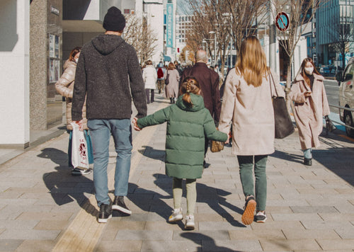 A family walking down the sidewalk holding hands ir-23-photo-intro.jpg__PID:10485fd0-9cde-4f00-9900-20e7b489ef36