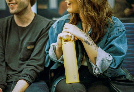 A woman holding a MiiR Wide Mouth Bottle